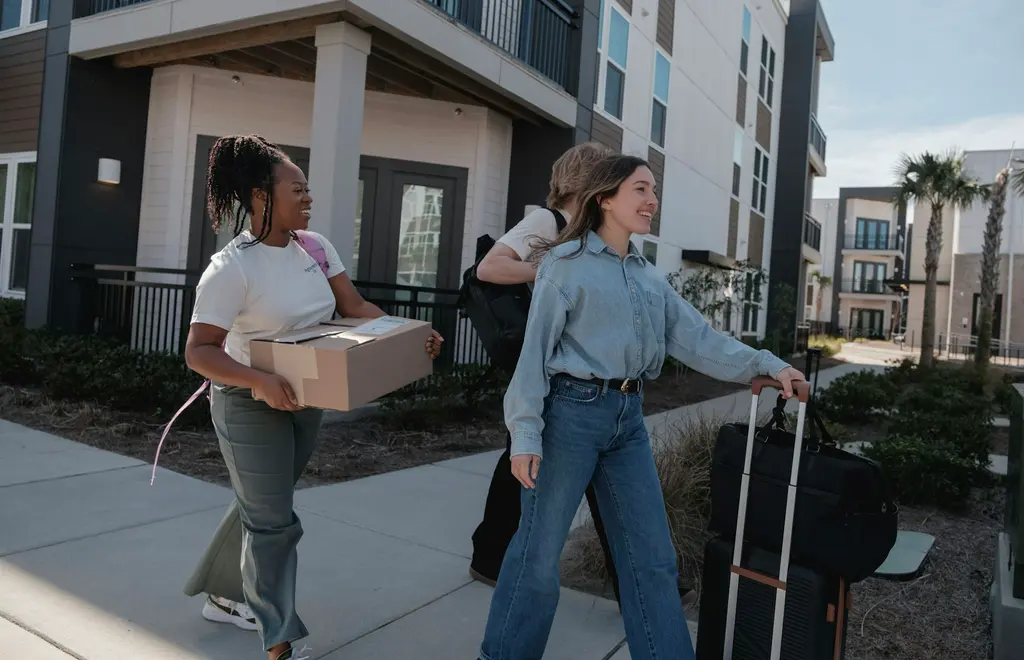 Boxes and furniture during a move into an apartment, illustrating student and relocation rental types
